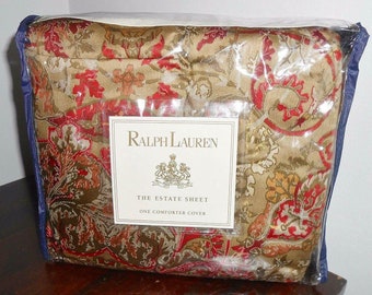 May include: A Ralph Lauren comforter cover in a plastic bag. The cover is a gold and red paisley pattern. The label reads "Ralph Lauren The Estate Sheet One Comforter Cover."
