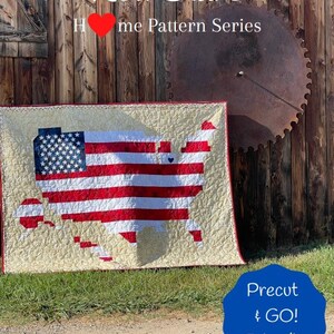 May include: A quilt depicting the United States of America in red, white and blue with a small heart in the centre. The quilt is titled "And the Rocket's Red Glare" and is part of the "Home Pattern Series". The quilt is precut and ready to go. It was designed by Brooke Stambersky of Brooke's Bitchin' Stitches.