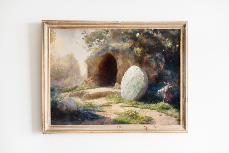 May include: A framed oil painting depicting a stone tomb with a large boulder rolled away from the entrance. The tomb is set in a lush, green landscape with trees and flowers. The painting is done in a realistic style with soft, muted colors.