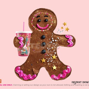 May include: A brown gingerbread cookie figure with a pink icing smile, three black button accents, and pink icing swirls on the hands and feet. The figure holds a pink cup with a straw and is decorated with small gold stars and white sprinkles.