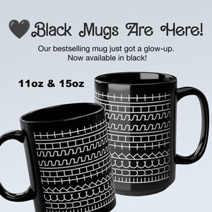 May include: Two black ceramic mugs with white geometric patterns. The mugs are available in 11oz and 15oz sizes. Text on the image reads "Black Mugs Are Here!" and "Our bestselling mug just got a glow-up. Now available in black!"
