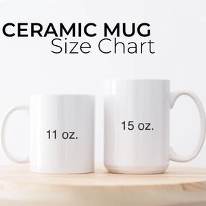 May include: Two white ceramic mugs, one labeled "11 oz." and the other "15 oz." The text "CERAMIC MUG Size Chart" is above the mugs. The mugs are on a light brown wooden surface.