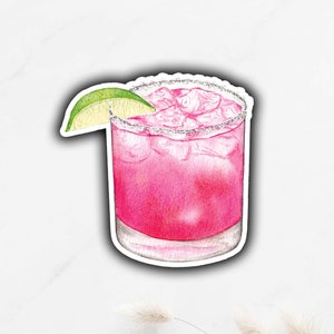 May include: A pink margarita cocktail with a lime wedge in a glass with a salted rim.