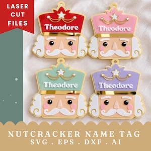 Peut inclure: Quatre étiquettes nominatives casse-noisette avec le nom Theodore imprimé sur chacune. Les étiquettes présentent des chapeaux rouge, rose, vert menthe et lavande avec des accents dorés, des cheveux et moustaches blancs.