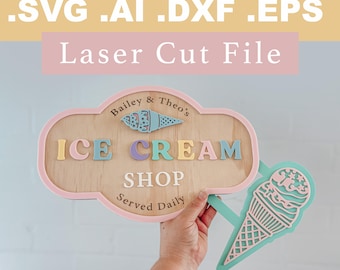 May include: Wooden ice cream shop sign with pastel colors. The sign reads "ICE CREAM SHOP Served Daily" and includes a decorative ice cream cone. The sign is a laser cut file, with the file types .SVG .AI .DXF .EPS.