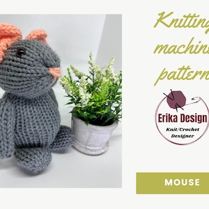 May include: Knitting machine pattern for a gray mouse with pink ears. The pattern is by Erika Design, Knit/Crochet Designer. The image shows a finished knitted mouse.