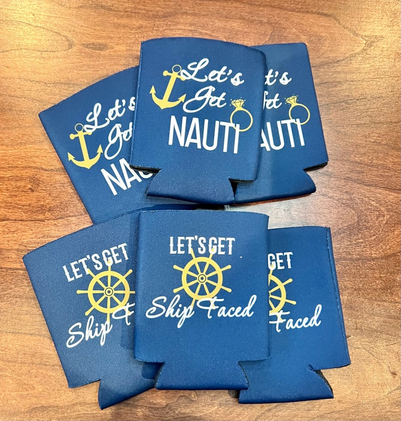 May include: Navy blue drink koozies with white and gold text. The koozies have nautical themes, with phrases like "Let's Get Nauti" with an anchor and ring graphic, and "Let's Get Ship Faced" with a ship's wheel.
