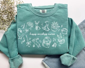 Hoppy Onkologie-Krankenschwester-Sweatshirt, Komfortfarben Ostern Onc-Krankenschwester-Shirt Krebs-Krankenschwester-Shirt, Peds RN Pediatric Oncology Nurse Abschlussgeschenk