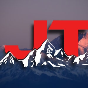 May include: A red and white logo design featuring the letters "JT" with a mountain range behind the letters. The logo is set against a blurred background of a mountain range with a pink and blue sky.