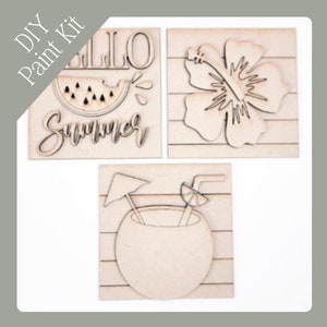 May include: DIY paint kit featuring three wooden cutouts with a summer theme. Includes a watermelon slice, hibiscus flower, and a coconut drink. The kit includes the words "Hello" and "Summer".