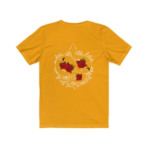 May include: A yellow t-shirt featuring a white graphic of a snake entwined with roses. The snake is curled into a circle and has a crescent moon on its head. The roses are red and have a white outline.