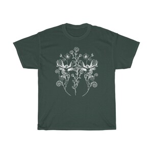 May include: Dark green t-shirt featuring a white floral design with two fairies. The design includes flowers, leaves, and swirling details. The t-shirt is made of a soft, comfortable material.
