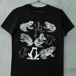 May include: Black t-shirt with a white graphic print of various frogs. The frogs are in different poses and sizes.