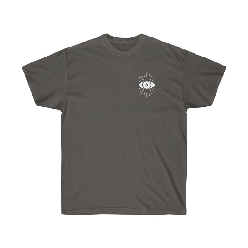 May include: A charcoal gray t-shirt with a white eye design. The eye has a white pupil and is surrounded by radiating lines.