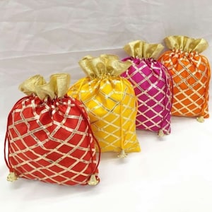May include: Four small drawstring bags with gold and red, gold and pink, gold and orange, and gold and yellow patterned designs.