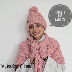 May include: A pink crocheted hat with a pom pom on top, a matching pink crocheted scarf and gloves, and the text "CROCHET PDF PATTERN" in a speech bubble.