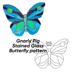 May include: A stained glass butterfly pattern with blue, green, and black glass pieces. The pattern is labeled "Gnarly Pig Stained Glass Butterfly".