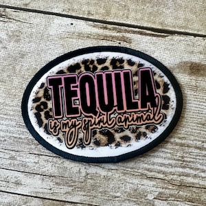 May include: A black and white oval patch with a leopard print background. The text "TEQUILA is my spirit animal" is written in pink and black letters.