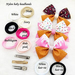 May include: Assortment of nylon baby headbands in various colors, including white, nude, ivory, black, hot pink, and pale pink.  Also included are matching hair ties in white and black.