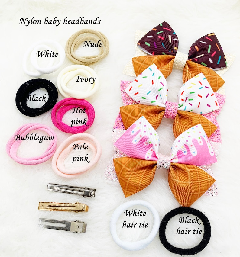 May include: Assortment of nylon baby headbands in various colors, including white, nude, ivory, black, hot pink, and pale pink.  Also included are matching hair ties in white and black.