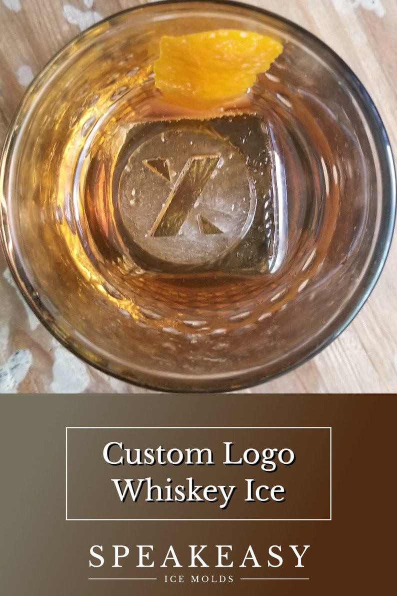 May include: A close-up of a whiskey glass with a custom logo ice cube and an orange peel garnish. The ice cube has a letter "X" design. The text "Custom Logo Whiskey Ice" and "SPeakeasy Ice Molds" is displayed below the image.
