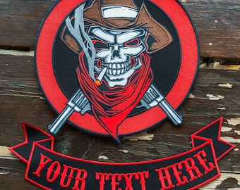 May include: Red and black embroidered patch featuring a skull wearing a cowboy hat and bandana, holding a cigarette and two crossed pistols. The patch has a red circle around the skull and the text "YOUR TEXT HERE" on a black banner.