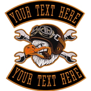 May include: Embroidered patch with a cartoon eagle wearing a helmet and goggles, holding a cigar, and crossed wrenches. The patch has a black background with orange text that says "YOUR TEXT HERE" on the top and bottom.