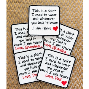 May include: Five white fabric patches with black text and a red heart. The text reads "This is a shirt I used to wear and whenever you hold it know I am there" followed by "Love, Grandma", "Love, Grandpa", "Love, Dad", and "Love, Da".