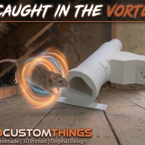 May include: A white 3D-printed plastic vacuum attachment with a triangular opening and a standard electrical outlet port. The image features the text CAUGHT IN THE VORTEX! and 3DCUSTOMTHINGS Handmade | 3D Printed | Original Design with a rat graphic.