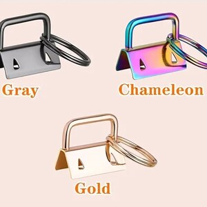 May include: Set of 10 metal key rings in various colours, including silver, grey, chameleon, rose gold, bronze, gold, and black. Each ring has a small loop for attaching keys or other items.