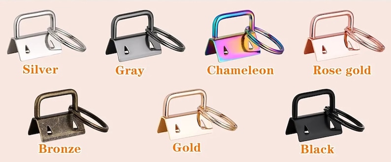 May include: Set of 10 metal key rings in various colours, including silver, grey, chameleon, rose gold, bronze, gold, and black. Each ring has a small loop for attaching keys or other items.