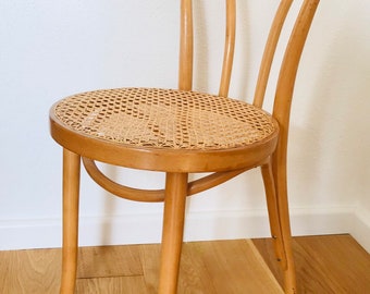 A beautiful, decorative chair made of wood and ratan.