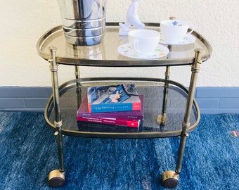 French bar trolley / serving trolley / tea trolley made of brass with two smoked glass plates from the 60s