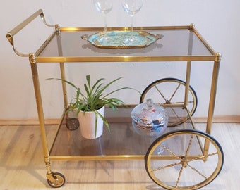 Very beautiful neoclassical mid-century bar cart / serving cart made of brass from the 70s.