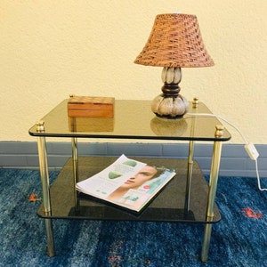 beautiful mid-century side table made of brass and smoked glass.