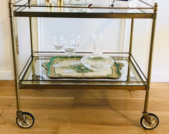 Exclusive, XXL neoclassical bar cart / serving cart made of brass with two glass plates on rubber wheels from the 50s.