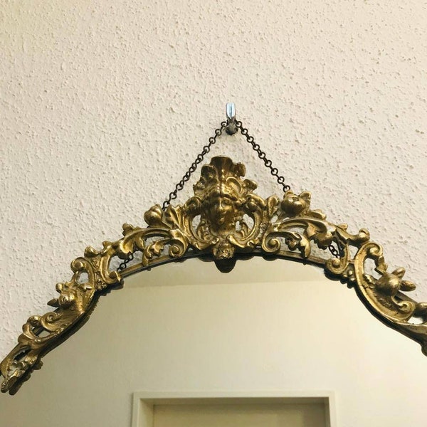 A decorative Biedermeier, old mirror / wall mirror with a brass frame from the 50s.