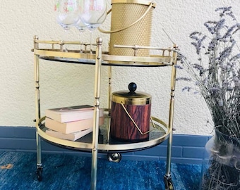 A beautiful neoclassical French bar cart / serving cart made of high quality brass from the 1950s