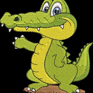 May include: Embroidered design of a friendly cartoon alligator with a green body, yellow belly, and blue eyes. The alligator is smiling and waving, with a brown patch of ground beneath its feet. The design is on a black background.