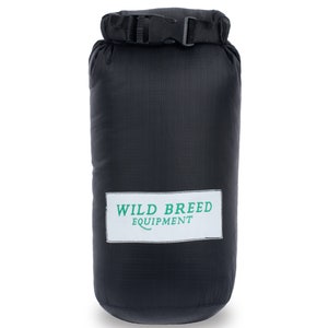 May include: Black dry bag with a black strap and buckle. The bag has a white label with green text that reads "WILD BREED EQUIPMENT".