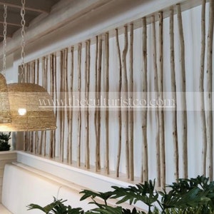 May include: Interior design featuring a natural wood screen made of vertical branches. Woven pendant lights hang from the ceiling. The website address www.theculturistco.com is visible on the screen.