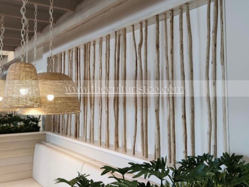 May include: Interior design featuring a natural wood screen made of vertical branches. Woven pendant lights hang from the ceiling. The website address www.theculturistco.com is visible on the screen.