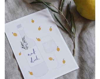 May include: A white card with a hand-drawn illustration of a bottle of wine, a glass of wine, and lemons. The bottle has the text "auf dich" written on it.
