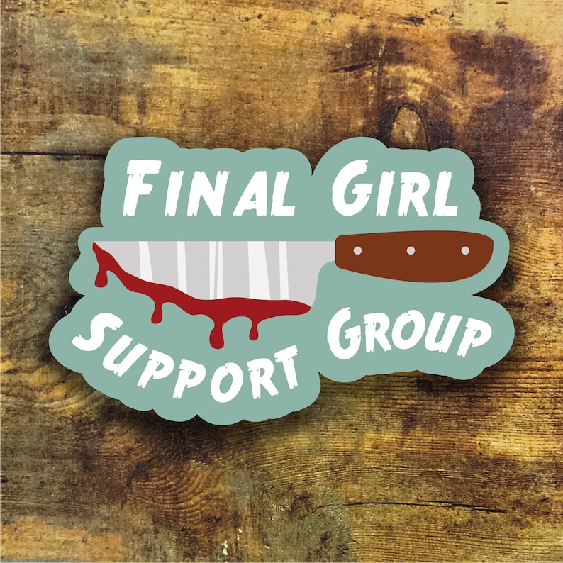 May include: A light blue sticker with the text "Final Girl Support Group" and a cartoon image of a bloody knife.