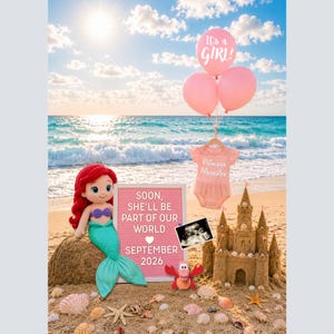 May include: A beach scene with a sandcastle, a plush Ariel doll, and a sign announcing a baby girl due in September 2026. Pink balloons with "It's a GIRL!" and a baby outfit are also featured.