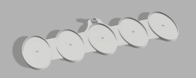 May include: A 3D-rendered, off-white, multi-disc holder. The holder features five circular platforms connected by a flat, rectangular base. Each platform has a central hole. A small, rectangular tab extends from the base.