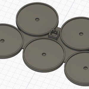 May include: A 3D-rendered, gray plastic component featuring five circular platforms with central holes, connected by a flat base. A small, rectangular structure is integrated into the design, possibly for additional functionality.