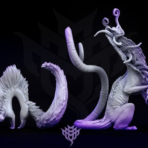 May include: A collection of stylized, light purple fantasy creature sculptures. The creatures have cat-like features with elongated limbs, tails, and unique head structures. The sculptures are set against a dark background.