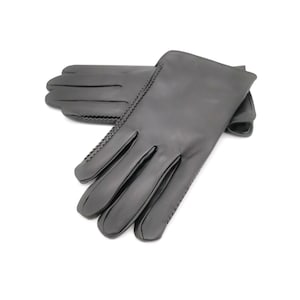 May include: A pair of black leather gloves with a stitched detail.