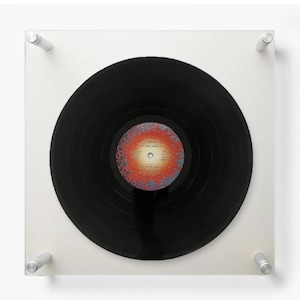 May include: A set of three ceramic mugs with a speckled, matte finish. The mugs are in shades of cream, light gray, and dark gray. Each mug has a simple, minimalist design and a rounded handle.